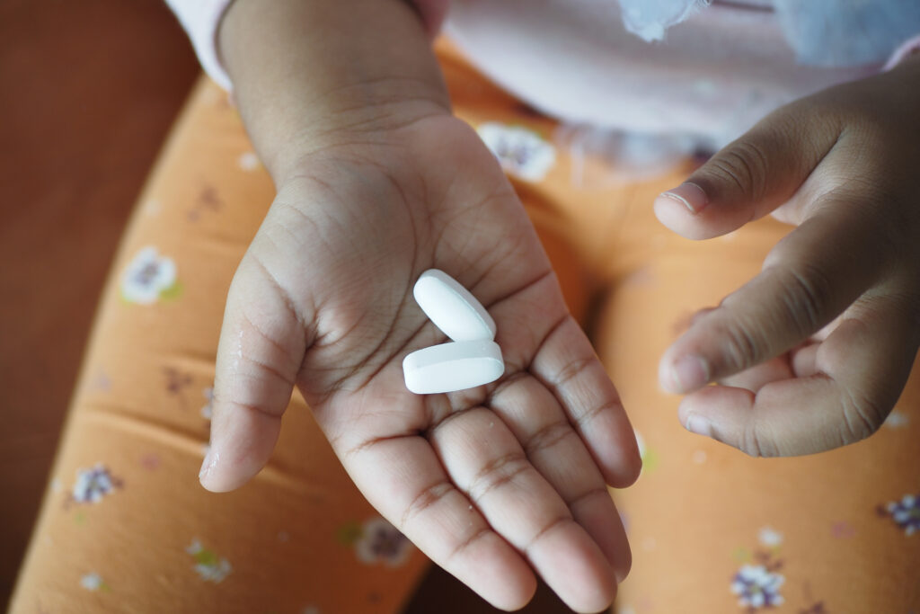 Human taking pills for deworming